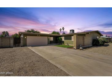 Charming single-level home with a spacious driveway and desert landscaping at twilight at 3537 W Shangri La Rd, Phoenix, AZ 85029
