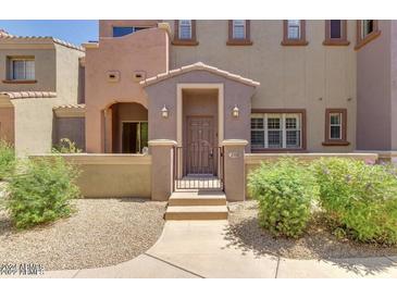Charming townhome facade with private gated entry and landscaped front yard at 3935 E Rough Rider Rd # 1101, Phoenix, AZ 85050