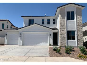 Charming two-story home featuring a three-car garage, stone facade, and well-maintained landscaping at 4924 W Brown St, Glendale, AZ 85302