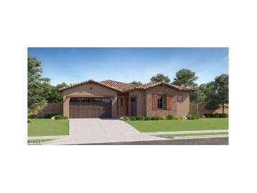 Charming single-story home with a tile roof, desert landscaping, and an attached two-car garage at 17473 W Victory St, Goodyear, AZ 85338