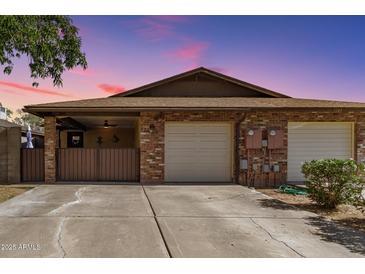 Charming brick home with a two-car garage and cozy covered patio, perfect for outdoor relaxation and curb appeal at 1807 E Jamaica Ave, Mesa, AZ 85204