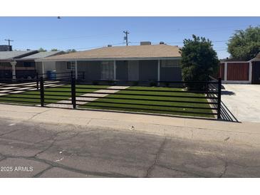 Charming home featuring a low fence with artificial turf and a lovely walkway at 2831 W Montecito Ave, Phoenix, AZ 85017