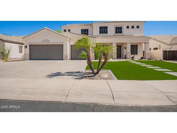Charming two-story home with a well-manicured lawn, complemented by a spacious driveway and a three-car garage at 3059 E Parkview Dr, Gilbert, AZ 85295