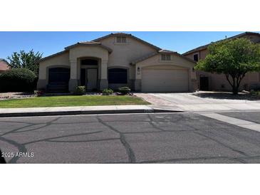 Charming single-Gathering home with a well-maintained lawn, mature tree, and a two car garage at 4525 E Runaway Bay Dr, Chandler, AZ 85249