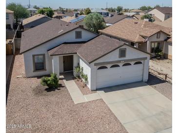 Charming single-story home featuring a two-car garage, neutral paint, and low maintenance desert landscaping at 11601 W Bloomfield Rd, El Mirage, AZ 85335