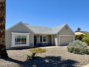 Charming single-story home with manicured front yard and attached garage, providing comfortable living and curb appeal at 1319 E Piute Ave, Phoenix, AZ 85024