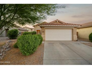 Charming single-story home with a two-car garage, desert landscaping, and a warm, inviting curb appeal at 2006 W Gold Dust Ave, Queen Creek, AZ 85144