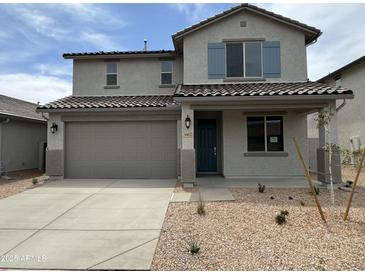 Charming two-story home features a two car garage, blue door, and low maintenance desert landscaping at 31822 N Bandit Rd, San Tan Valley, AZ 85143
