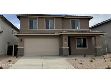 Two-story home with a two car garage and neutral colored stucco finish, complemented by a well-maintained yard at 31850 N Bandit Rd, San Tan Valley, AZ 85143