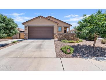 Charming single-story home featuring a well-kept lawn, stone accents, and a two-car garage at 3597 E Henson St, San Tan Valley, AZ 85140