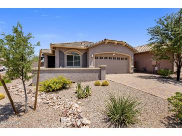 Charming single-story home with well-maintained desert landscaping and a two-car garage at 4230 W Palace Station Rd, New River, AZ 85087
