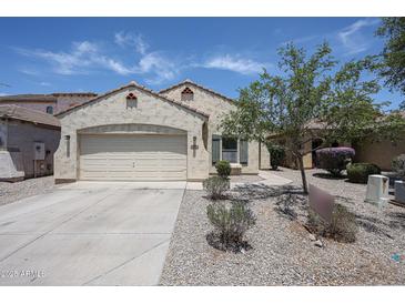 Charming single-story home with two car garage and desert landscaping at 5418 W Carson Rd, Laveen, AZ 85339