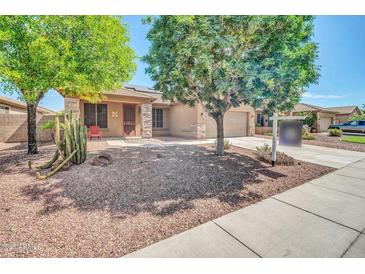 Charming single-Gathering home with desert landscaping, mature trees, and a two-car garage at 11318 W Monte Vista Rd, Avondale, AZ 85392