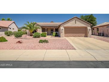 Charming single-story home featuring desert landscaping and a two-car garage at 15314 W Pantano Dr, Surprise, AZ 85374