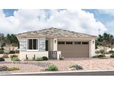 Charming single-story home featuring stone accents, desert landscaping, and a two-car garage at 15814 W Vogel Ave, Goodyear, AZ 85338