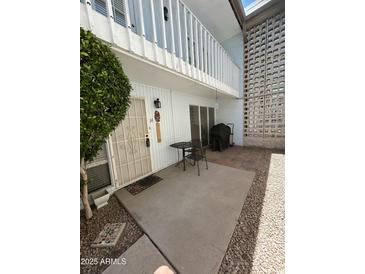 Inviting patio featuring a table, grill, and access to upper balcony, perfect for relaxing or entertaining at 1734 W Tuckey Ln # 14, Phoenix, AZ 85015