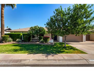 Charming single story home showcasing a well-manicured lawn, mature trees, and inviting curb appeal at 1862 E Tulane Dr, Tempe, AZ 85283