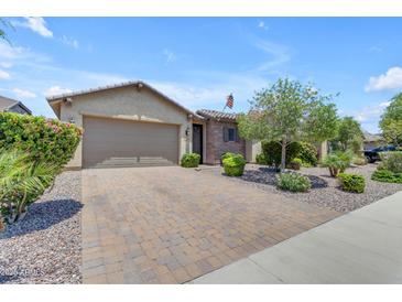 Charming single-story home with a paver driveway, low maintenance landscaping, and a two car garage at 19606 W Grant St, Buckeye, AZ 85326