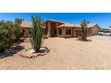 Inviting single-story home with desert landscaping and a terracotta-tiled roof under a clear blue sky at 20670 N 41St Ave, Glendale, AZ 85308