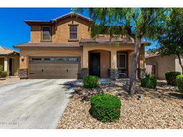 Charming two-story home featuring a well-manicured lawn, covered porch, and attached two-car garage at 27189 N 75Th Dr, Peoria, AZ 85383