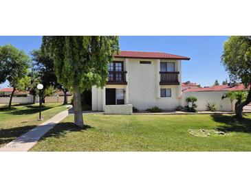 Charming two-story home with a red tile roof and front yard at 2831 E Waltann Ln # 1, Phoenix, AZ 85032