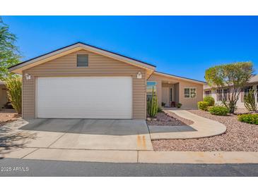 Charming single-story home features a two-car garage and low maintenance desert landscaping at 3301 S Goldfield Rd # 1048, Apache Junction, AZ 85119
