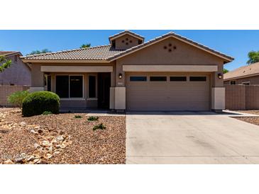 Charming single-story home featuring a low maintenance desert landscape and a two-car garage at 3719 E Sandy Way, Gilbert, AZ 85297
