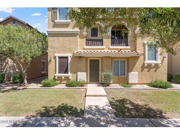 Charming home featuring a quaint balcony and well-manicured front lawn at 4212 E Jasper Dr, Gilbert, AZ 85296