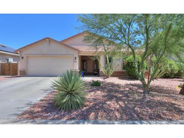 Charming single-story home featuring desert landscaping and a two-car garage at 45138 W Norris Rd, Maricopa, AZ 85139