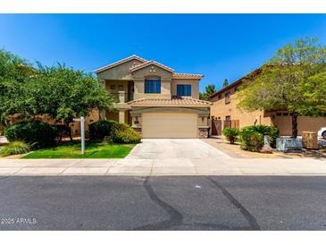 Charming two-story home featuring desert landscaping, tile roof, and an attached two-car garage at 5234 E Carol Ave, Mesa, AZ 85206