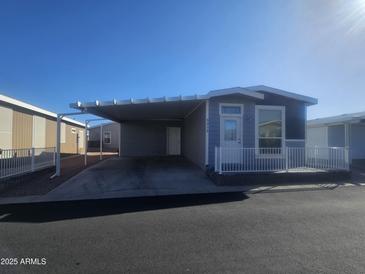 Charming single-Gathering home with carport, small front porch and well-maintained landscaping at 650 N Hawes Rd # 3312, Mesa, AZ 85207