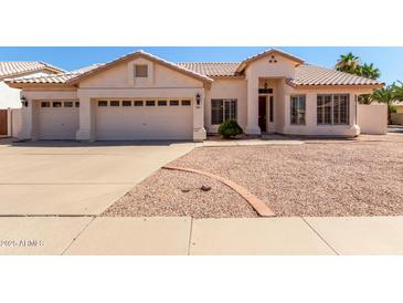 Charming single-story home featuring a well-maintained front yard, a two-car garage, and a welcoming entrance at 871 W Mesquite St, Gilbert, AZ 85233
