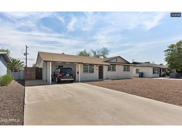 Charming single-story home with a covered carport and low maintenance desert landscaping at 1321 W 14Th St, Tempe, AZ 85281