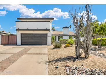Contemporary home with a two-car garage, desert landscaping, and a well-maintained front yard at 5435 E Cambridge Ave, Phoenix, AZ 85008