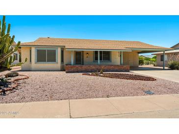 Charming single-story home featuring a desert landscape, covered entryway, and a carport on a sunny day at 839 Leisure World --, Mesa, AZ 85206