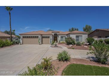 Charming single-story home with a well-manicured front yard and large driveway at 17770 N 66Th Ln, Glendale, AZ 85308