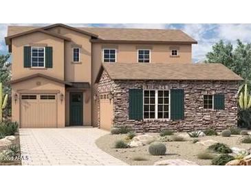 Inviting two-story home showcasing stone accents, a two-car garage, and a welcoming front entry at 1972 W Rowel Rd, Phoenix, AZ 85085