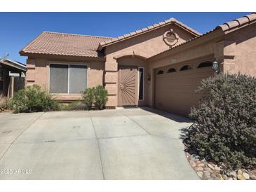 Charming single-story home with desert landscaping, a tile roof, and a two-car garage at 2125 E Danbury Rd, Phoenix, AZ 85022