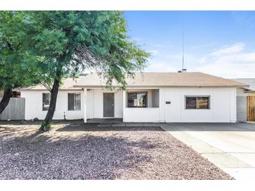 Charming single-story home featuring a well-maintained front yard and neutral color palette at 4833 N 63Rd Ln, Phoenix, AZ 85033