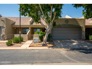 Charming single-story home with well-maintained landscaping and a spacious two-car garage at 64 N 63Rd N St # 33, Mesa, AZ 85205