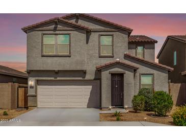 Charming two-story home featuring a two-car garage and neatly manicured landscaping at 7413 S 32Nd Dr, Phoenix, AZ 85041