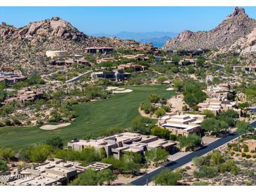 Scenic aerial view of homes in a golf community, with desert landscaping and mountain views at 10641 E Blue Sky Dr, Scottsdale, AZ 85262