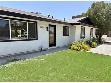 Charming home with well-manicured lawn, inviting curb appeal, and fresh exterior paint at 1421 W Pasadena Ave, Phoenix, AZ 85013