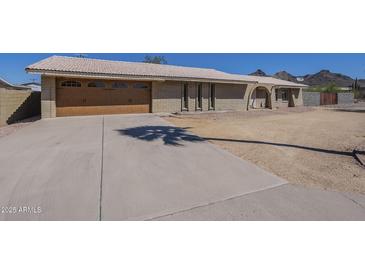Charming single-story home featuring a tile roof, spacious driveway, and a two car garage at 1530 E Loma Ln, Phoenix, AZ 85020
