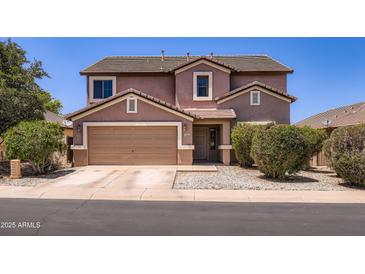 Charming two-story home with a two-car garage, desert landscaping, and a classic suburban appeal at 18182 W Desert Ln, Surprise, AZ 85388