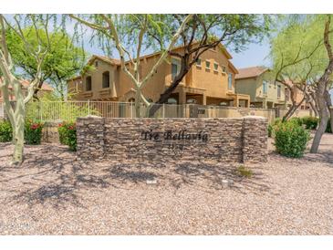 Inviting property entrance with stone signage and beautifully landscaped surroundings at 2150 E Bell Rd # 1088, Phoenix, AZ 85022