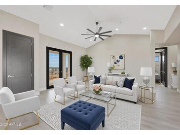 Bright living room boasts contemporary furnishings, neutral tones, and stylish decor for comfortable living at 25846 W Denver Hill Dr, Wittmann, AZ 85361