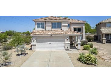 Charming two-story home with a tile roof, desert landscaping, and a spacious two-car garage at 31259 N 42Nd Pl, Cave Creek, AZ 85331