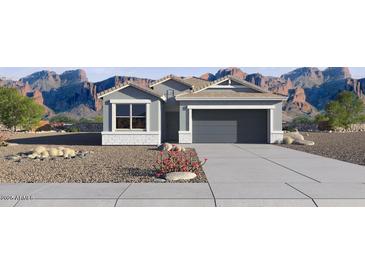 Charming single-story home showcasing a well-maintained lawn, 2-car garage, and mountain views at 5496 E Axle Ln, San Tan Valley, AZ 85140