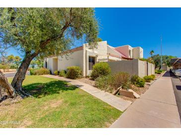 Charming single-story home with desert landscaping, mature shade tree, and covered parking at 7802 E Rovey Ave, Scottsdale, AZ 85250